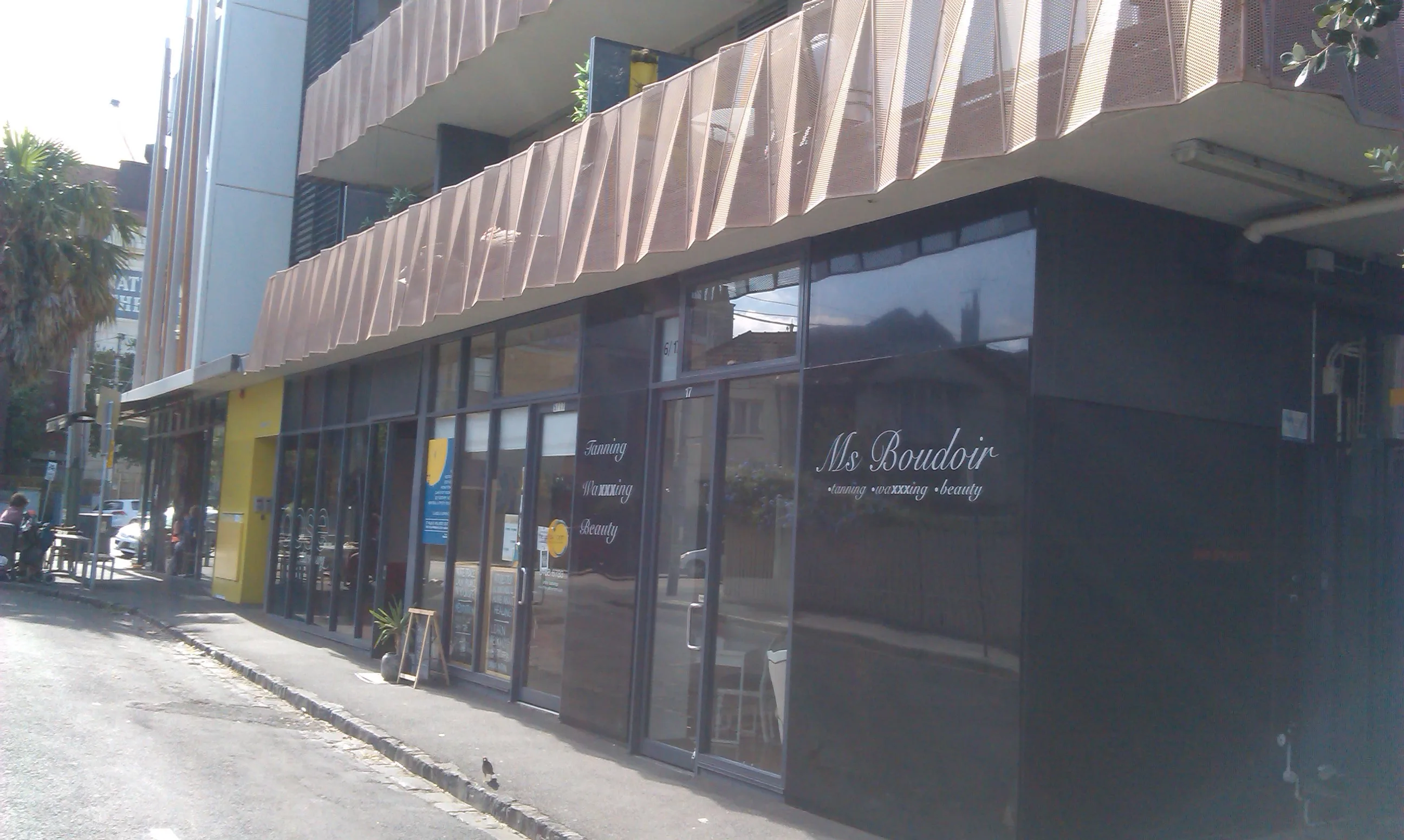 The Ms Boudoir shopfront on Irwell Street — dark glazed frontage with tanning, waxxxing and beauty in white on the glass